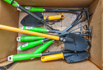 garden tool in cardboard box top view