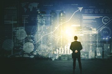 Back view of businessman using a futuristic HUD interface screen