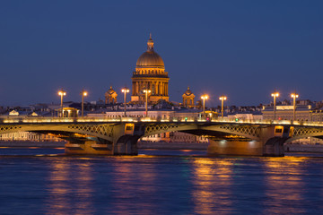Fototapeta premium The Annunciation Bridge and the dome of St. Isaac Cathedral in the night scenery. Saint-Petersburg, Russia