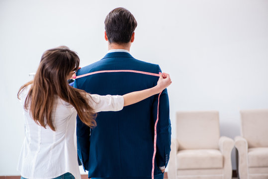 Professional Tailor Taking Measurements For Formal Suit