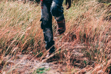 Man Walking through Grass