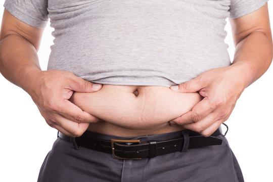 Close-up of man holding unhealthy big belly visceral subcutaneous fats