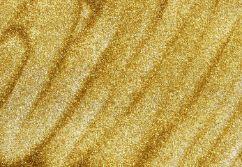 Fototapeta na wymiar Closeup of golden glitter dust spread diagonaly