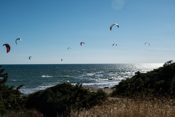 Summer sport background of kitesurf on a bright sunny day. Beautiful outdoor activity wallpaper.