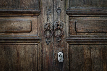 Old vintage retro style wood door with rusty handles background and texture.