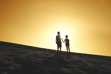 Fototapeta na wymiar Two children standing on the dune