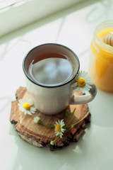 cup of herbal tea with chamomile flowers cozy home tea party concept, countryside still life