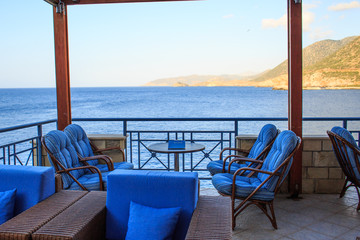 Elegant restaurant table waiting for customers by the sea outdoor terrace in Bali, Greece