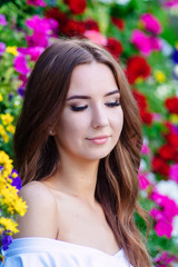 Obraz na płótnie Canvas Young teenage girl in a white dress circle of flowers.