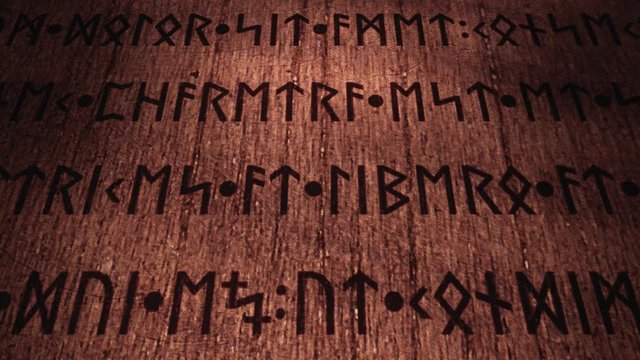 An ancient wooden tablet filled with carved runic signs, 3d panning from left to right. The text is fake, as it's the latin (public domain) Lorem Ipsum.
