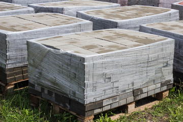 pallets with a paving slab made of mortar, brick, paving