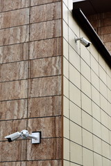 CCTV cameras are installed on the walls of the building corner. Protection of the territory around the clock