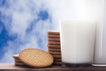 glass of milk and cookies on a blue background