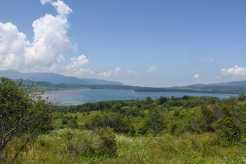Beautiful cloudy sky over the mountain lake. Vlasina lake in eastern Serbia