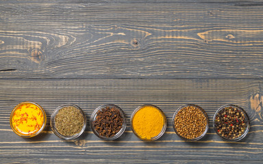 Spices for making curry sauce on a dark background. The view from the top. Copy-space.
