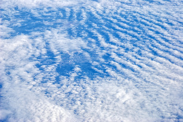 view from the plane above the clouds and the ground