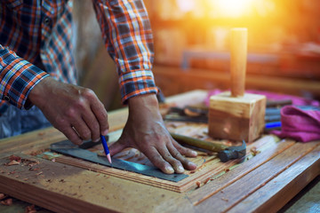 Asian carpenters work on woodwork in carpentry shops. Men work in carpenters.