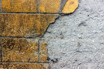 Piece of a ruined brick old wall background.