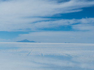 Uyuni Salt flats with bright blue sky and reflections