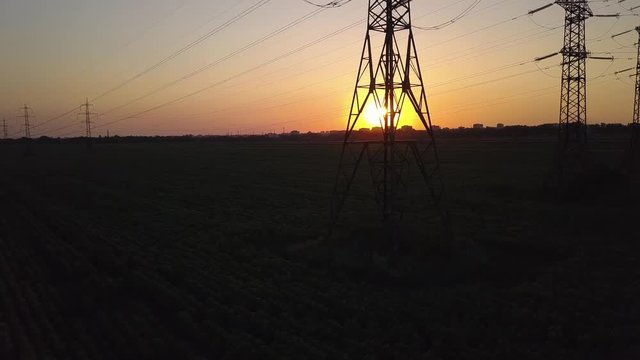 Aerial View of Sunset and High-voltage power pylon. Fuel and power generation. 4K