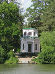 Fototapeta na wymiar covered with a green roof gazebo in the park near the lake. Uman Ukraine