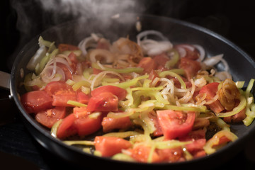 steaming mixed vegetables in the wok, vegetarian and healthy, selected focus, narrow depth of field