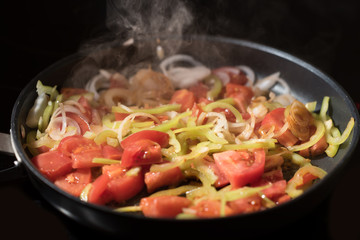 steaming mixed vegetables in the wok, vegetarian and healthy, selected focus, narrow depth of field