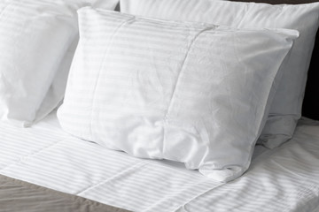 Fototapeta na wymiar white pillows on bed in modern bedroom at home