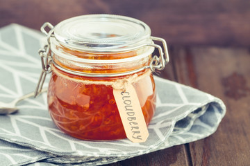 Glass jar with cloudberry jam. Nordic cuisine.