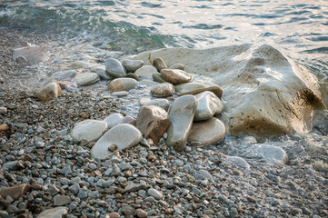 Large stones on the beach, washed by the wave