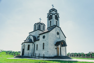Fototapeta na wymiar Small beautiful white church recently built with spectacular sky