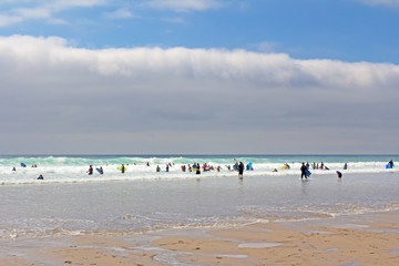 Surfers in sea in Cornwall