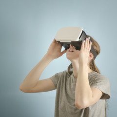 Yuong woman with glasses of virtual reality. Blue background