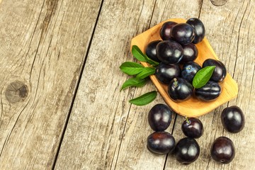 Fresh plums on a wooden table. Fruit harvest. Sales of fresh fruit.