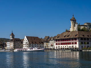 Obraz premium View above the Rhine river on the promenade with the restaurant Güterhof and the fortress Munot, Old Town, Schaffhausen, Canton Schaffhausen, Switzerland, Europe