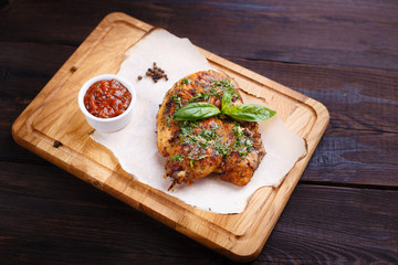 Grilled fried chicken fillet with herbs and spicy sauce, restaurant serving. Georgian cuisine, appetizing roasted meat, restaurant menu. 
