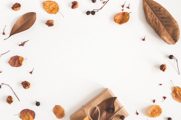 Autumn composition. Gift box, dried flowers and leaves on white background. Autumn, fall concept. Flat lay, top view, copy space