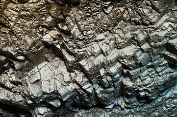 Grunge interesting surface of mountain rocks. Blue and Orange tint of stones