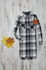 Checkered shirt and maple leaves. Fashionable concept