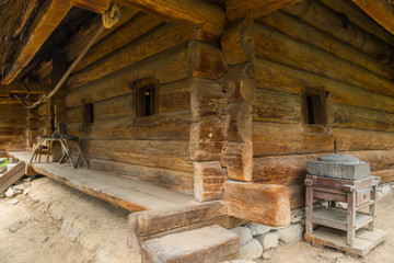Fototapeta na wymiar The old authentic Ukrainian hut, made of wooden beams with small windows in it