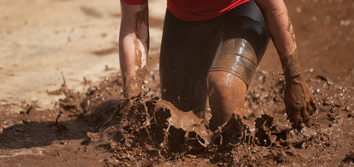 Mud race runners,during extreme obstacle races - obrazy, fototapety, plakaty