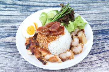 Jasmine rice with meat and boiled egg topped red sweet sauce .