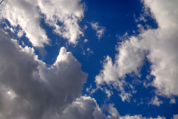 clouds in the blue sky blue saturated bright contrast.