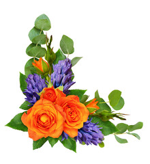 Orange roses and hyacinth flowers with eucalyptus leaves in a corner floral arrangement