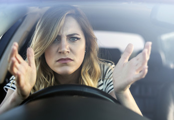 Angry woman driving a car.