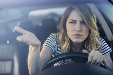 Angry woman driving a car.