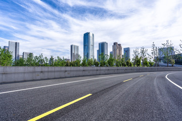Fototapeta na wymiar empty asphalt road with city skyline