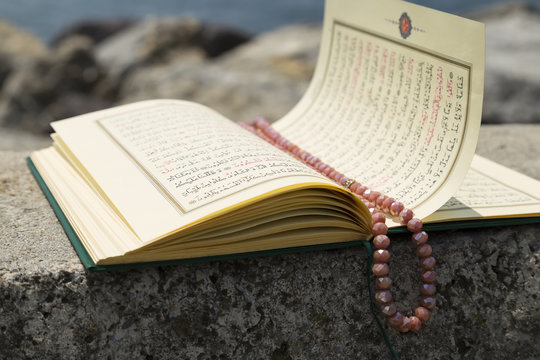 Koran and rosary on the background for Islamic concept. Holy book quran for Muslims holiday, Ramadan,blessed Friday message and three months.