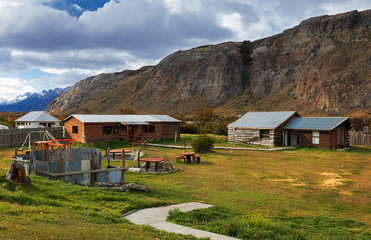 Small wooden houses on the background of mountains. El Chalten. Santa Cruz province. Argentina. Patagonia, South America