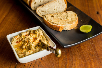 Hummus with sourdough bread on wooden jarrah board